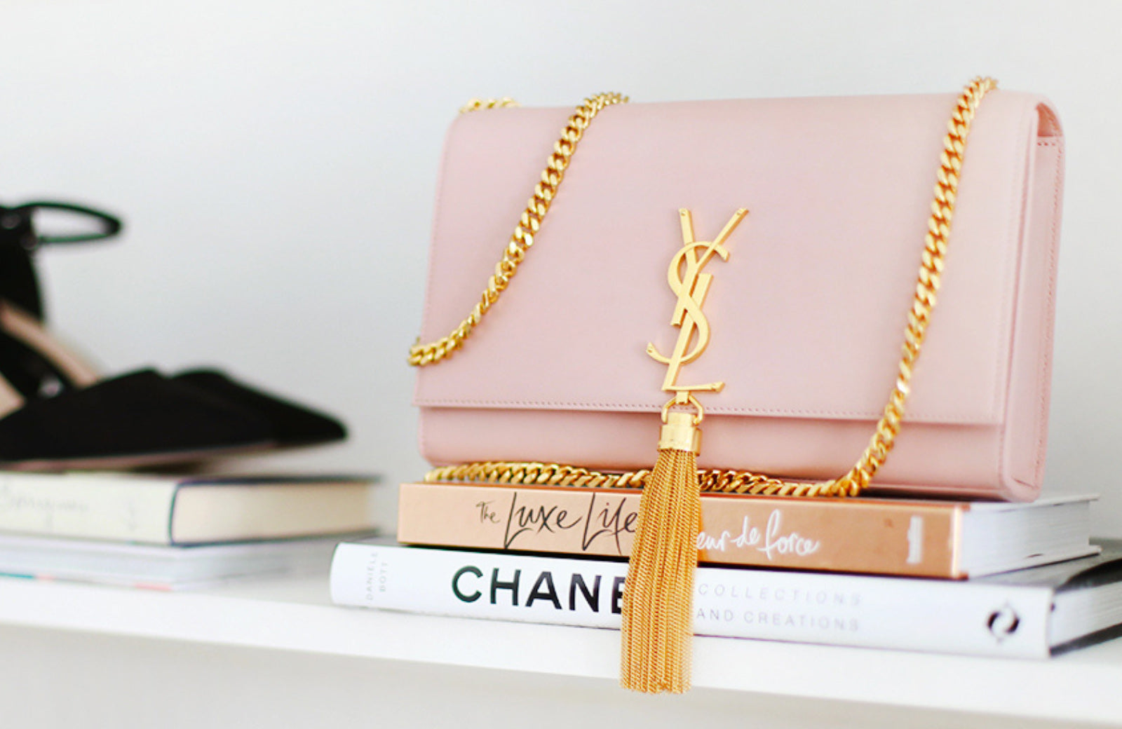 Saint Laurent Bag with Gold Tassel Sitting on Books 