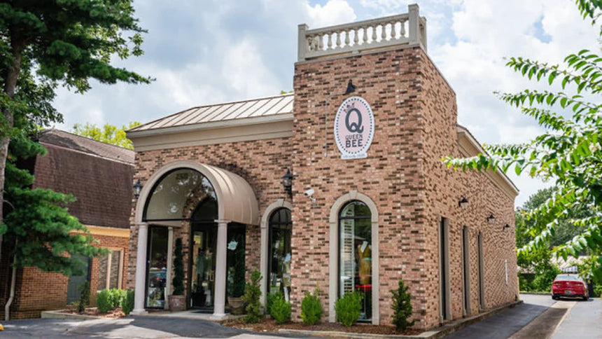 Brick Queen Bee of Beverly Hills store building on a clear day, luxury, designer bag and accessory retailer based in Huntsville, Alabama