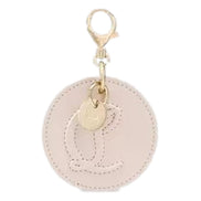 Christian Louboutin Round Leather Logo Leche Cream Bag Charm Keychain available at Queen Bee of Beverly Hills