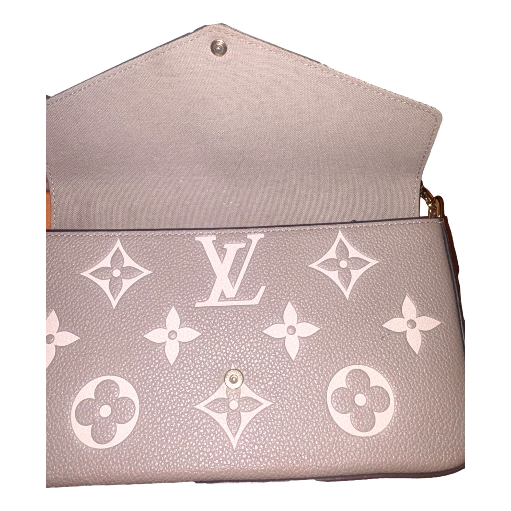 Louis Vuitton Pochette Felicie Monogram Empreinte Leather in Gray - available at Queen Bee of Beverly Hills.
