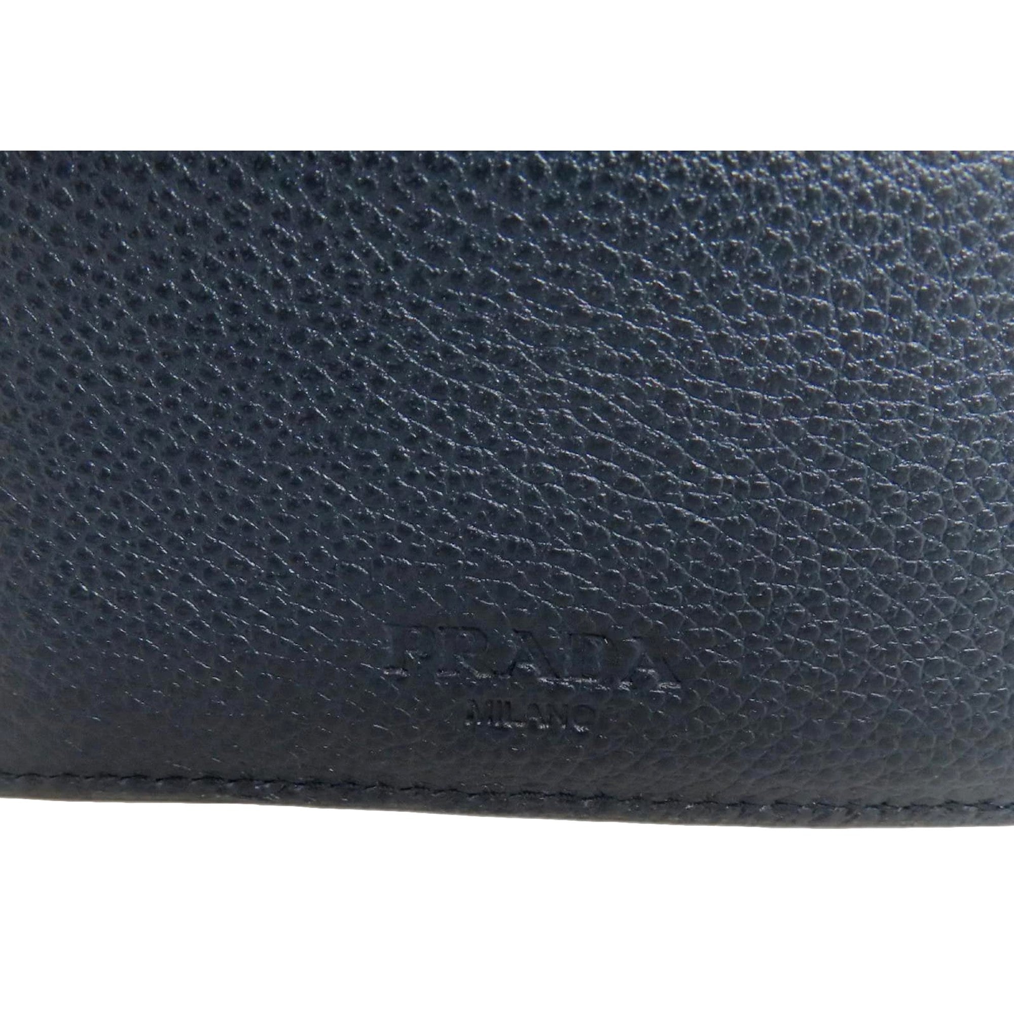Prada Black Vitello Micro Grain Leather Bifold Wallet Triangle Enamel Logo available at Queen Bee of Beverly Hills
