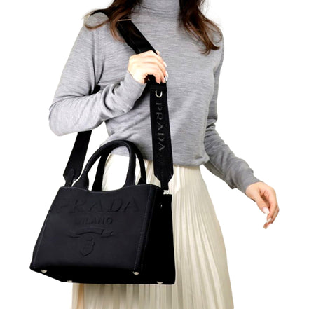Prada Canapa Tote Handbag Canvas Embossed Lettering Logo Fabric Black available at Queen Bee of Beverly Hills