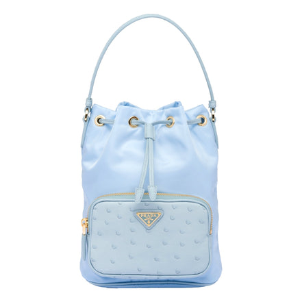Prada duet orstrich leather and nylon bucket bag in blue available at Queen Bee of Beverly Hills