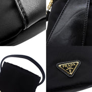 Prada Petit Sac Noir Mini Re-Nylon and Nappa Leather Bucket Bag Black - availablel at Queen Bee of Beverly Hills. 