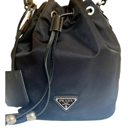 Prada Re-Nylon Black Tassel Drawstring Bucket Bag available at Queen Bee of Beverly Hills