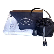 Prada Re-Nylon Black Tassel Drawstring Bucket Bag available at Queen Bee of Beverly Hills