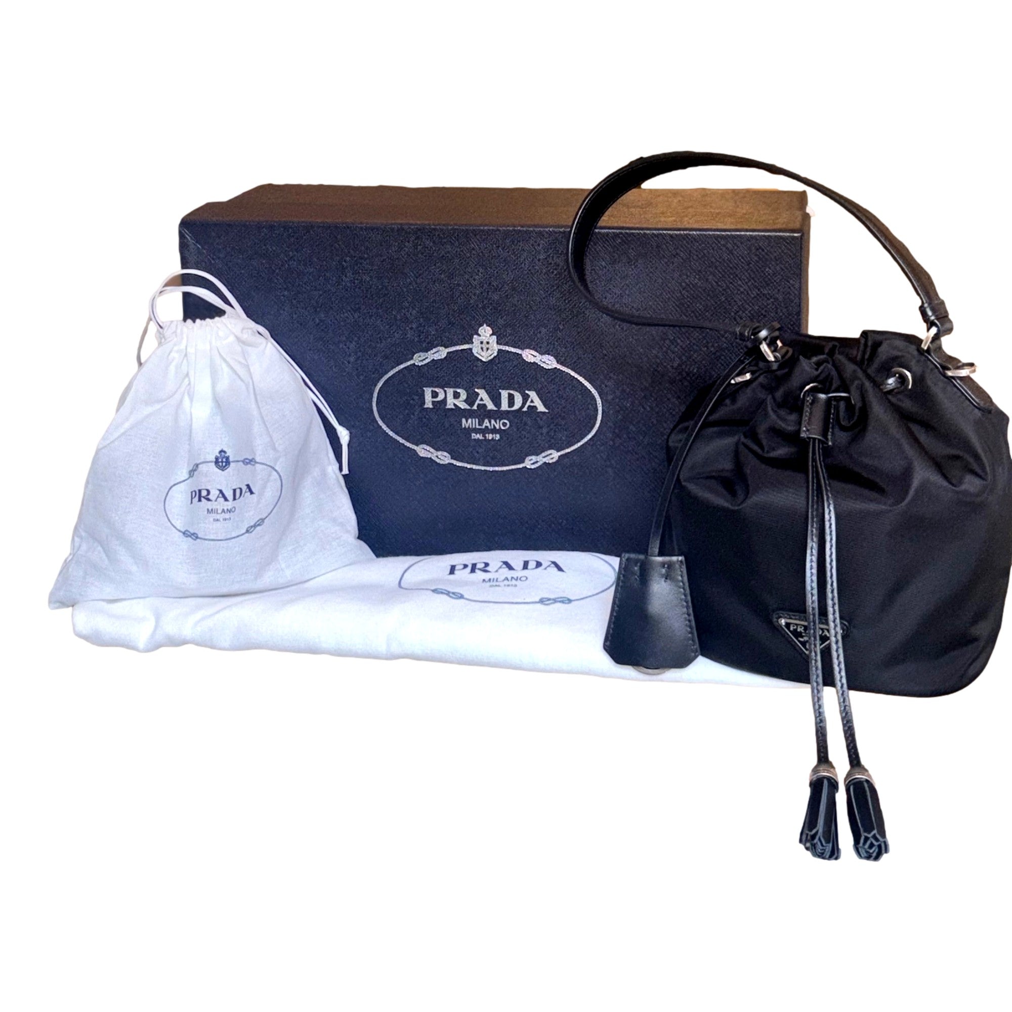 Prada Re-Nylon Black Tassel Drawstring Bucket Bag available at Queen Bee of Beverly Hills