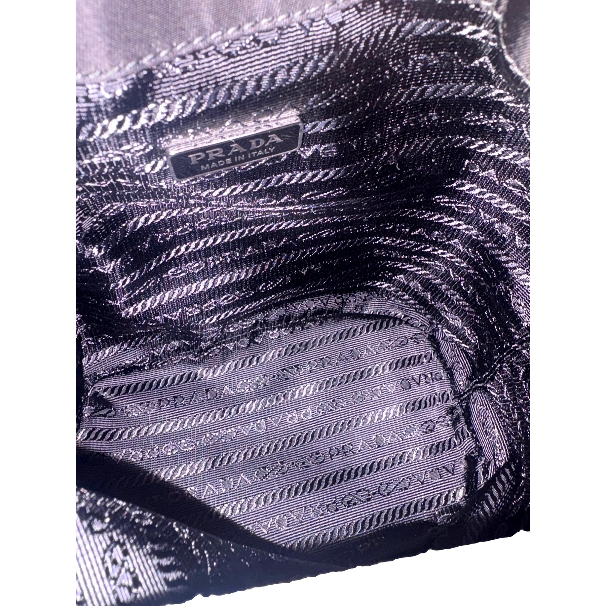 Prada Re-Nylon Black Tassel Drawstring Bucket Bag available at Queen Bee of Beverly Hills