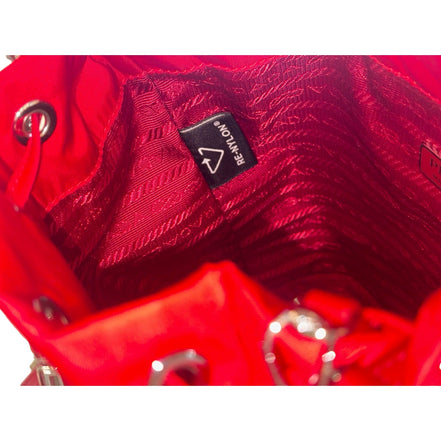 Prada Re-Nylon Rosso Red Drawstring Bucket Bag Embellished Crystal Handle available at Queen Bee of Beverly Hills