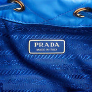 Prada Tessuto Nylon Pervinca Blue Duet Drawstring Quilted Bucket Bag available at Queen Bee of Beverly Hills