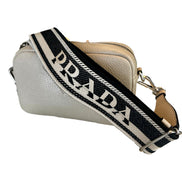 Prada Vitello Daino Leather Sabbia Beige Web Strap Camera Crossbody available at Queen Bee of Beverly Hills