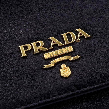 Prada Vitello Grain Black Trifold Compact Wallet Leather Logo Plaque available at Queen Bee of Beverly Hills