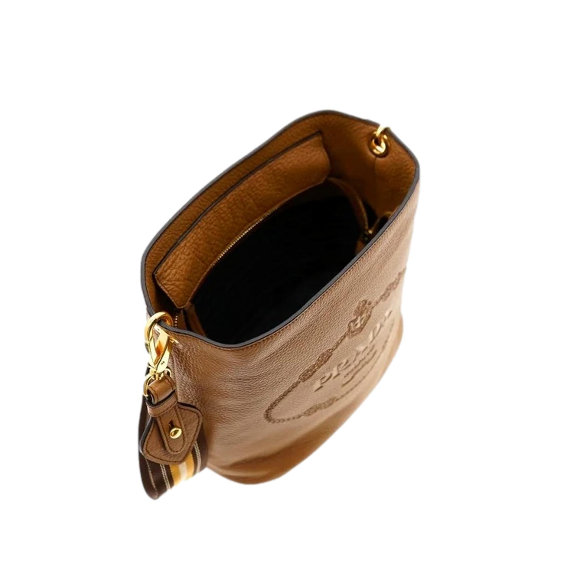 Prada Vitello Phenix Bucket Crossbody Bag Caramel Brown Web Strap available at Queen Bee of Beverly Hills