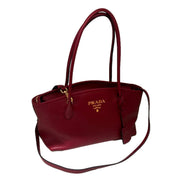 Prada Vitello Phenix Leather Rubino Red Top Handle Shoulder Bag available at Queen Bee of Beverly Hills