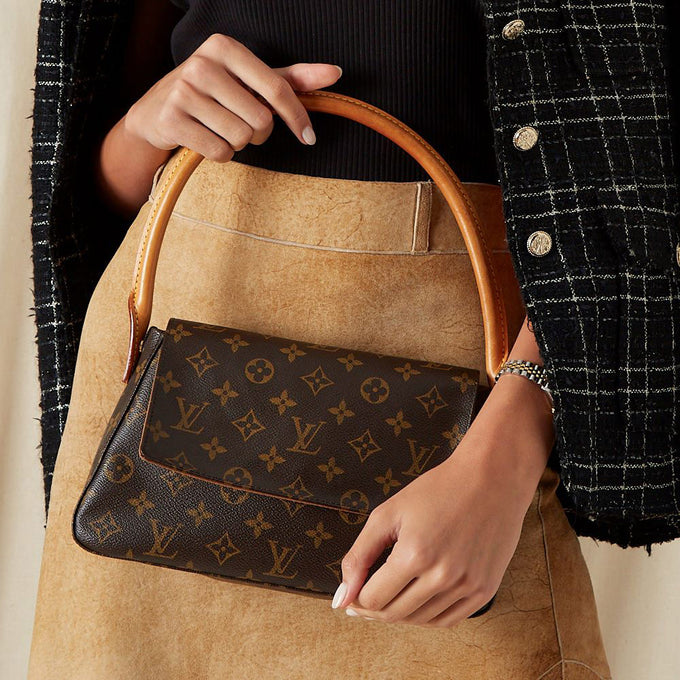 Close Up shot of woman holding Louis Vuitton monogram bag 