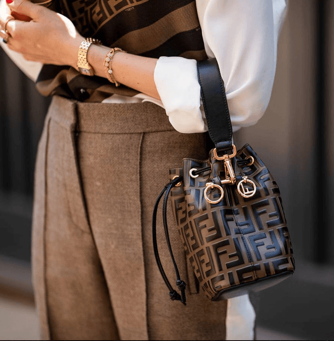 Detail shot of woman holding Fendi bucket bag