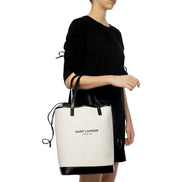 Saint Laurent Teddy White Coated Linen Drawstring Bucket Bag available at Queen Bee of Beverly Hills