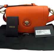 Versace Half-Moon La Medusa Vitello Leather Orange Crossbody Handbag available at Queen Bee of Beverly Hills