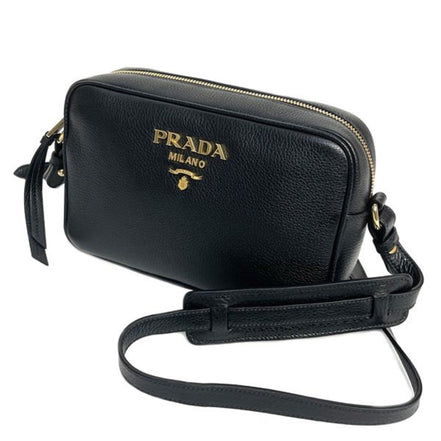 Prada Vitello Phenix Black Leather Gold Logo Camera Crossbody Bag available at Queen Bee of Beverly Hills