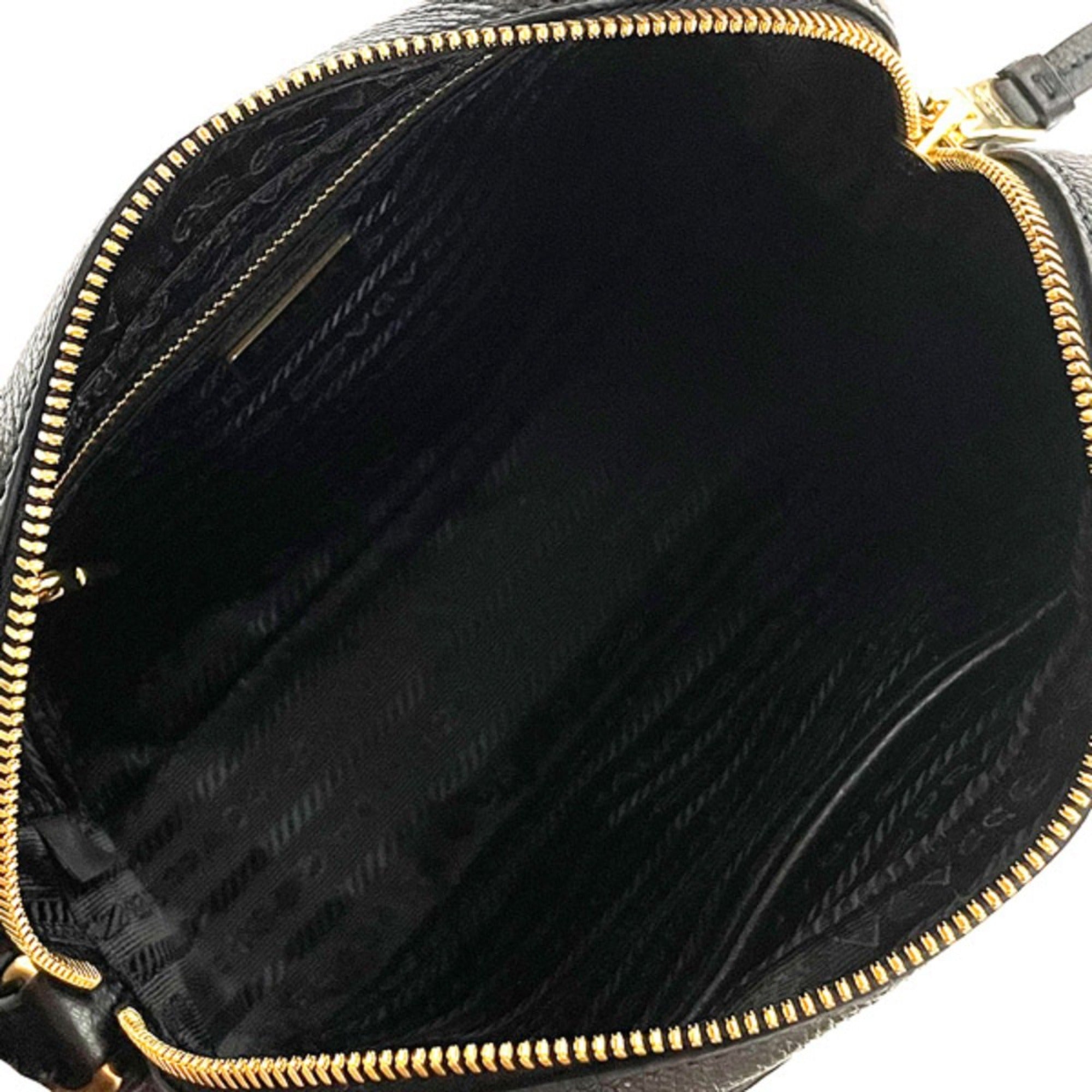 Prada Vitello Phenix Black Leather Gold Logo Camera Crossbody Bag available at Queen Bee of Beverly Hills